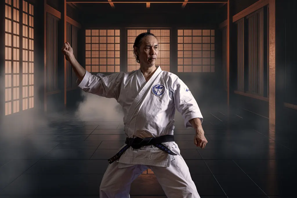Wado-Ryu karate instructor in a strong stance in a traditional wooden dojo